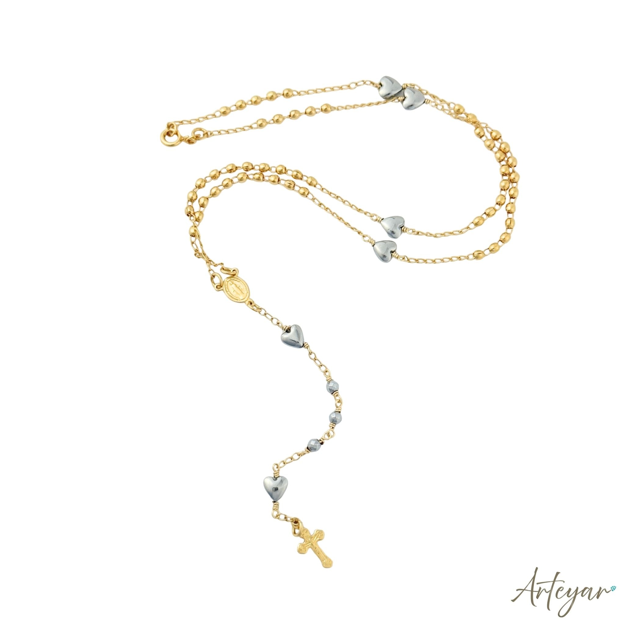 Golden Rosary with Heart-Shaped Hematite Beads, Gold Medal, and Cross, Rosary Design by Arteyar, Versatile for Prayer or as a Sophisticated Accessory.