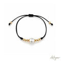 Elegant Black Cord Bracelet with a Luminous Central Pearl and Golden Beads, Lia Design by Arteyar, Minimalist and Classic Jewelry, Perfect for Solo Wear or Stacking.