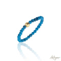 Minimalist ring with dark turquoise and central gold bead – Luce Dark Turquoise by Arteyar