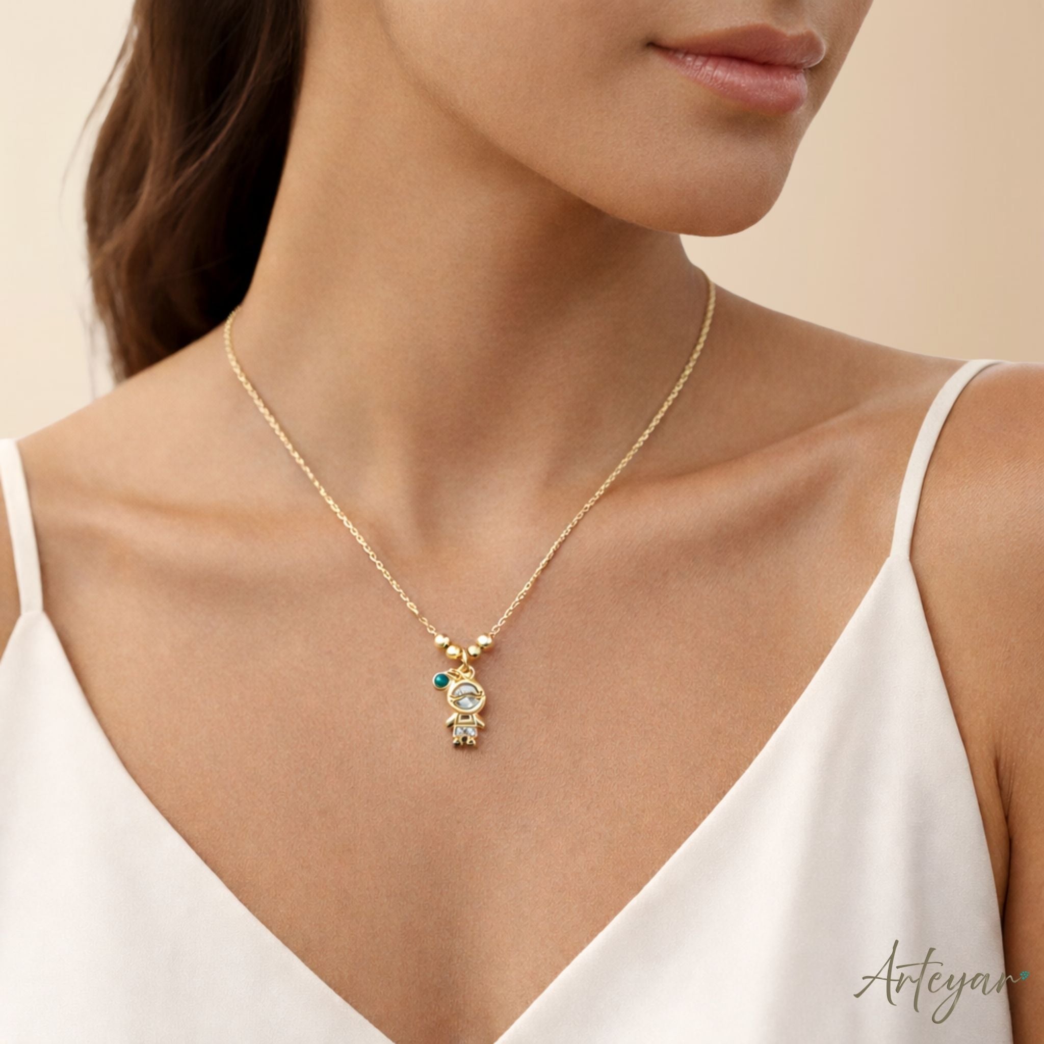 Delicate gold necklace with child-shaped pendant and crystals – Petit by Arteyar