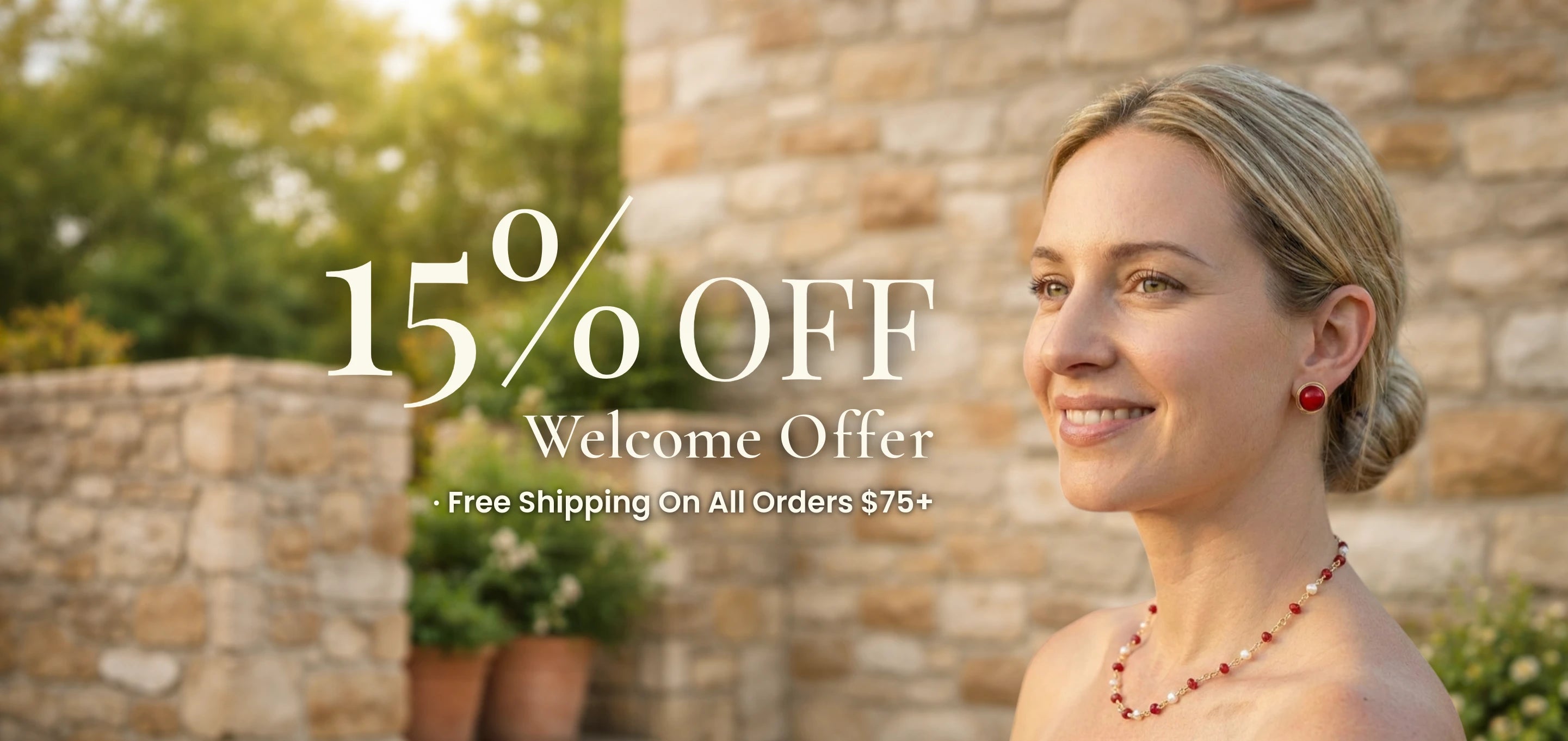 Woman wearing a pearl and red coral necklace smiling outdoors — 15% Off Welcome Offer · Free Shipping On All Orders $75+